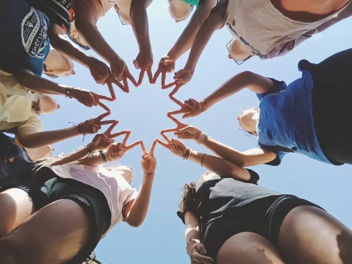 Grupo de jóvenes formando una estrella con las manos